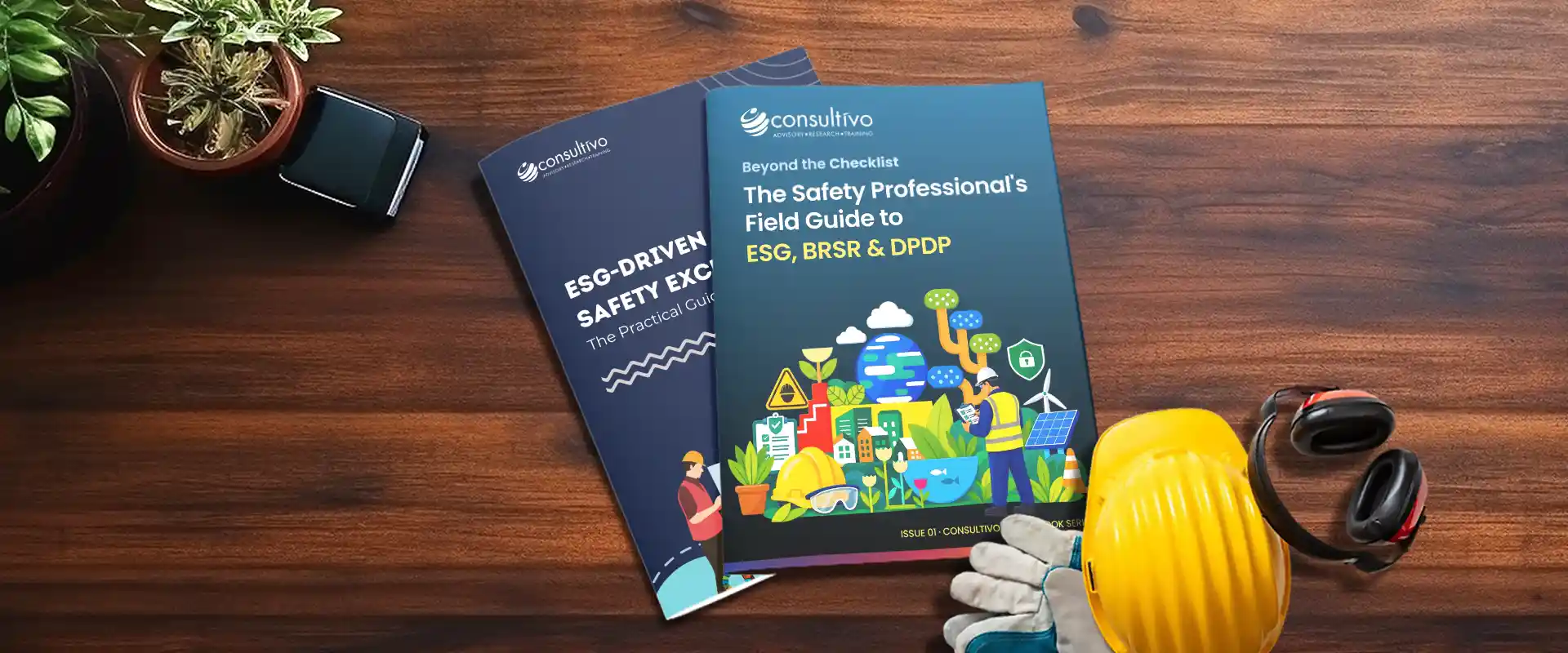 Consultivo Esg And Safety Guidebooks On A Desk With A Hard Hat And Safety Gear